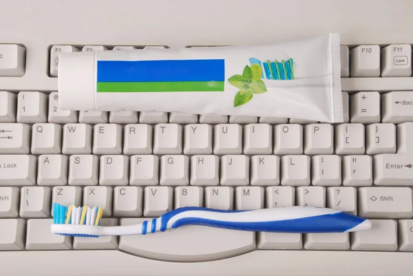 Computer keyboard, toothpaste and toothbrushes.