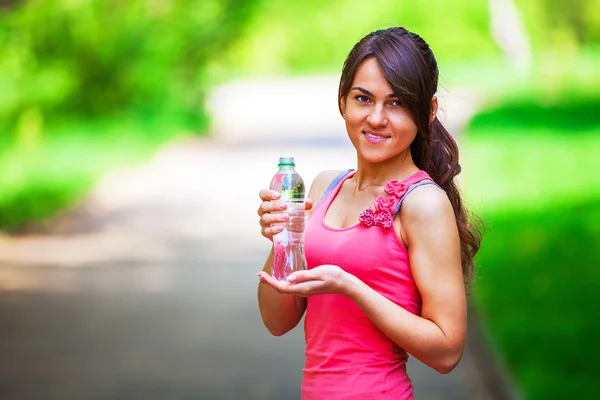 Girl drinks water after sport