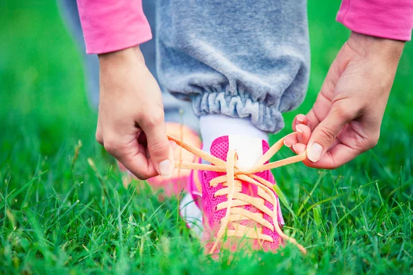 Girl laces up trainers