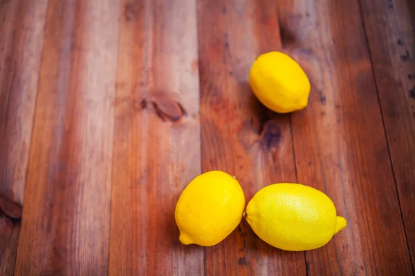 Ripe lemon isolated on a wooden background