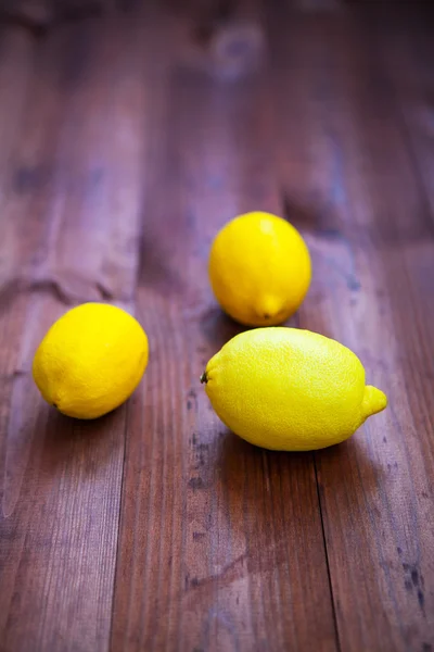 Ripe lemon isolated on a wooden background