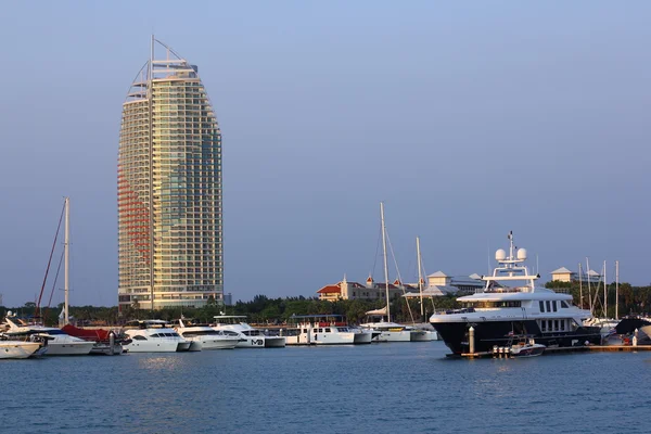 PATTAYA, THAILAND - MARCH 13 : The sailing boats and skyscraper in Marina yacht club Pattaya in evening time on March 13, 2016 in Pattaya, Thailand