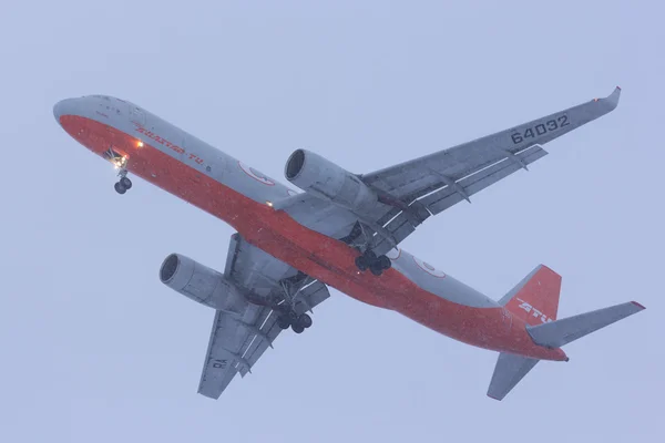 NOVOSIBIRSK - DEC. 19: Cargo Aircraft TU 204C by Aviastar -Tu airlines at Novosibirsk Tolmachevo Airport. Landing during shower snow. December 19, 2015 in Novosibirsk Russia