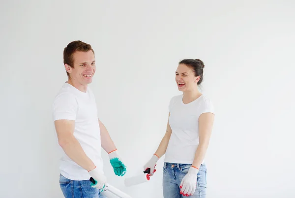 Young man and the woman laugh, beginning repair.