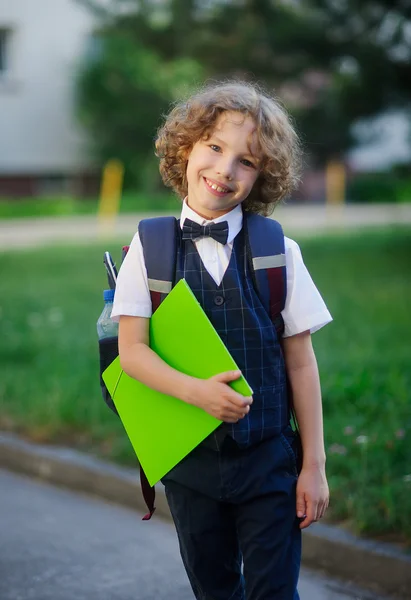 Elegant curly-haired first-grader in the school yard.