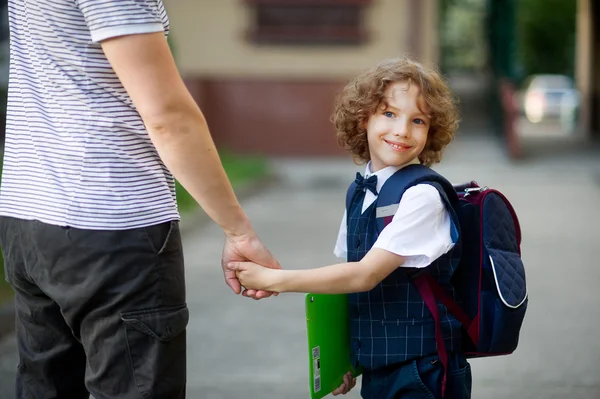 Cute little first grader goes to school.