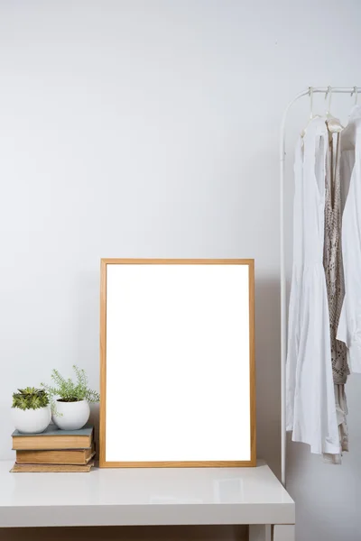 Empty wooden picture frame on the table, art print mock-up