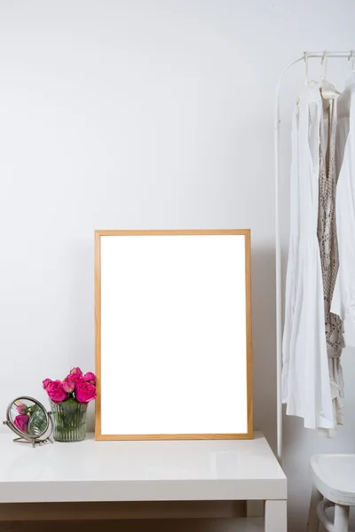 Empty wooden picture frame on the table, art print mock-up