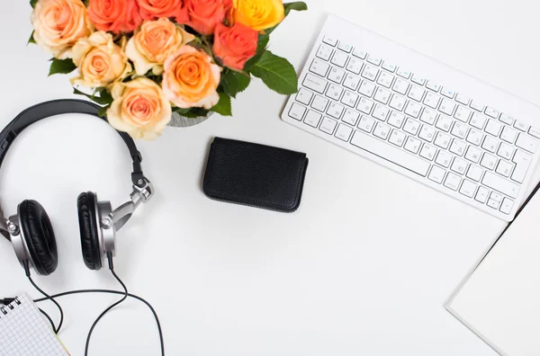 Feminine desk workspace with roses, startup concept