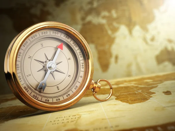 Vintage compass on the old world map. Travel concept.