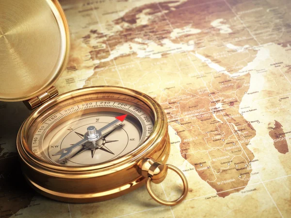 Vintage compass on the old world map. Travel concept.