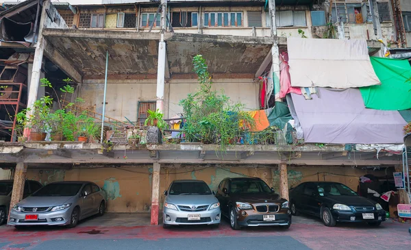 Cars Parked beneath an Old, but Unfinished Building in Bangkok
