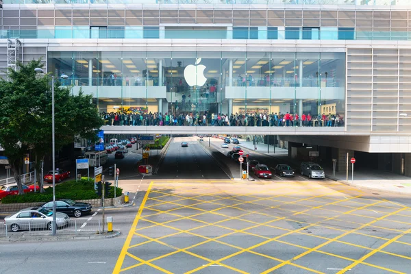 Crowd of people crossing in front of an Apple store, Hong Kong,