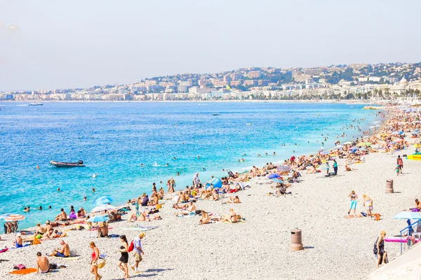 Tourists enjoy the good weather at the beach in Nice, France