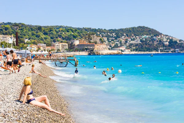 Tourists enjoy the good weather at the beach in Nice, France