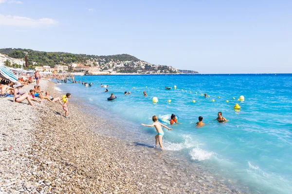 Tourists enjoy the good weather at the beach in Nice, France