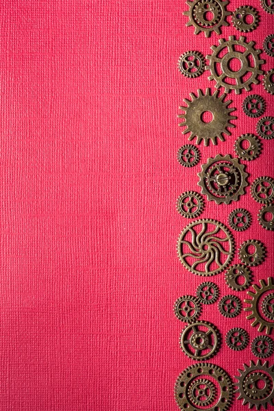 Steampunk mechanical cogs gears wheels on red background