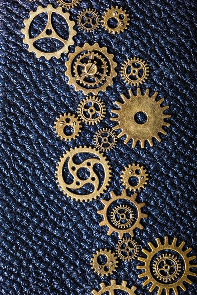 Steampunk mechanical cogs gears wheels on leather background
