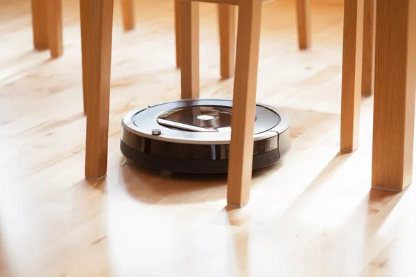 Robotic vacuum cleaner on laminate wood floor smart cleaning tec