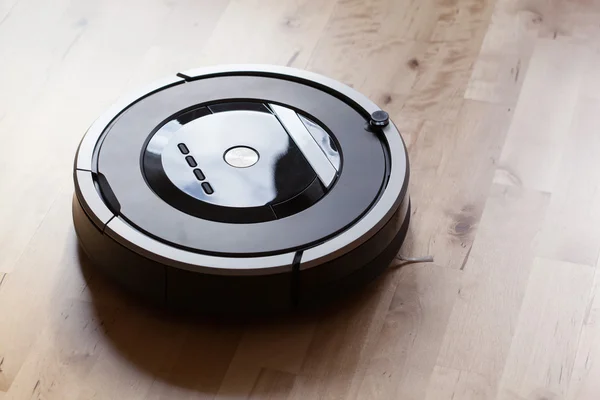 Robotic vacuum cleaner on laminate wood floor smart cleaning tec