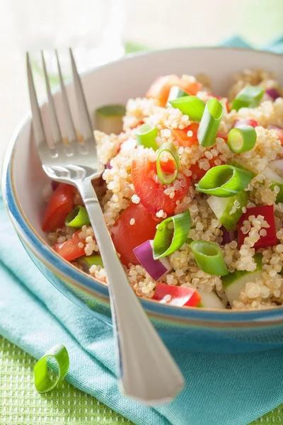 Healthy quinoa salad with tomato cucumber onion chives