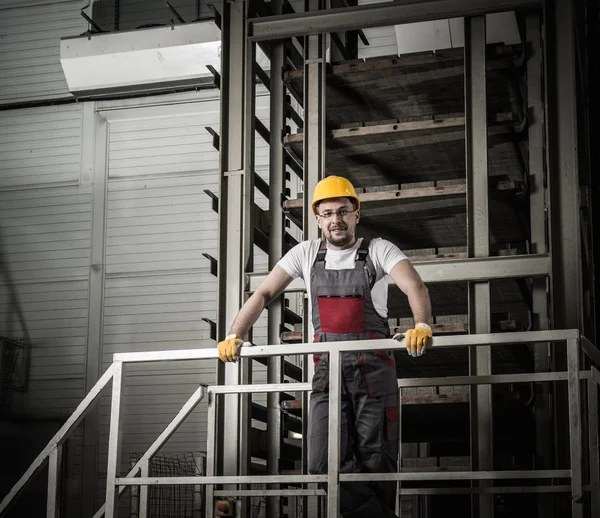 Man in a safety hat on a factory