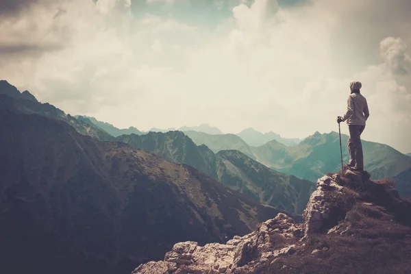 Woman hiker on a top of a mountain