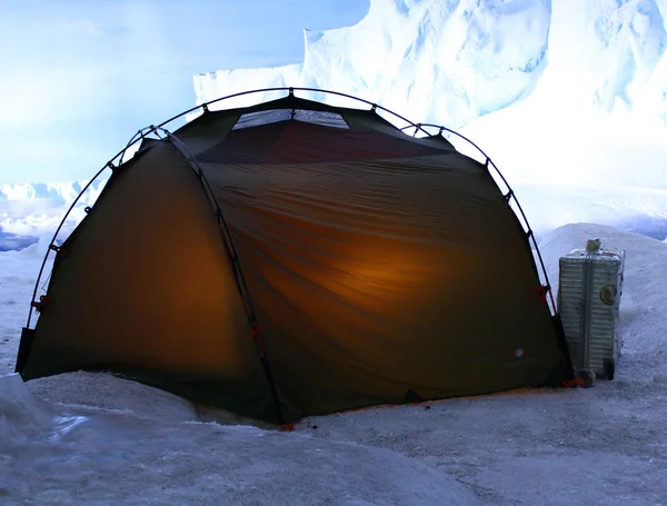 Tent in the mountains with snow and ice