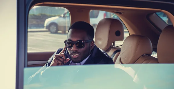 Man in the car talking on smartphone.