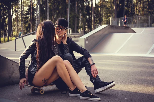 Casual couple in a skate park.