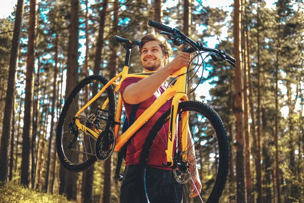 Male holding yellow mountain bicycle.