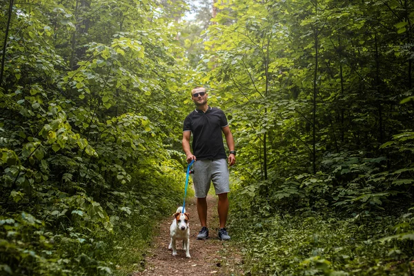 Attractive man on a walk with a dog