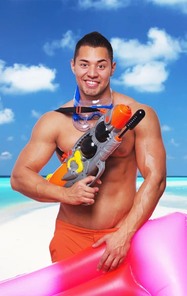 Muscular male holding water gun