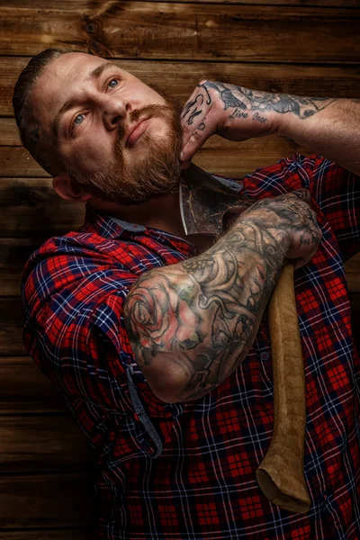 Huge brutal male with tattooes shaves his beard