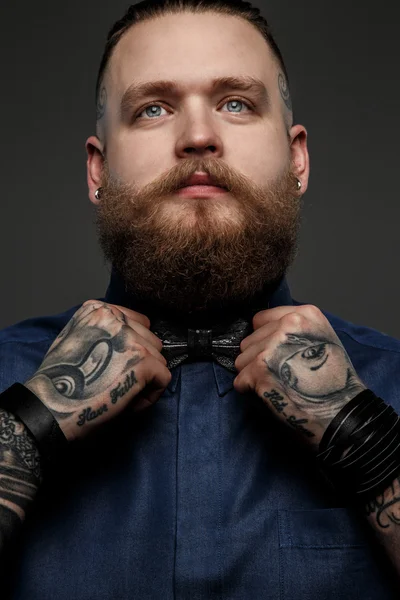 Man in blue shirt and bow tie.