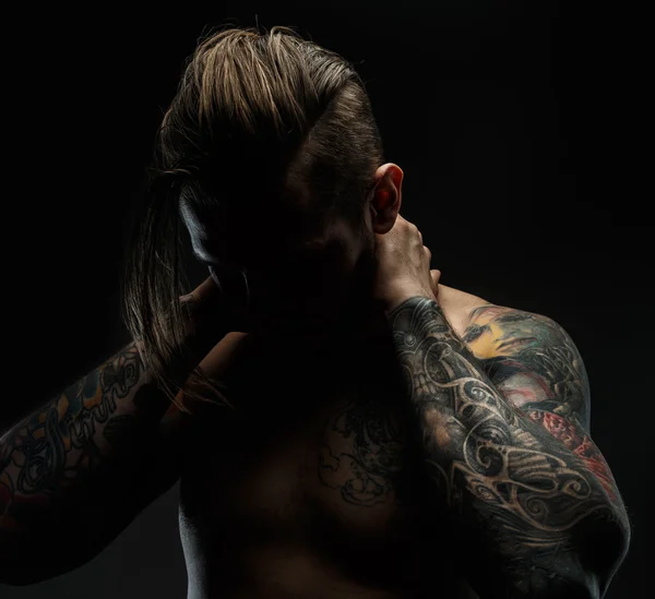 Portrait of a man with tattoos.