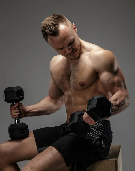 Muscular guy with dumbell