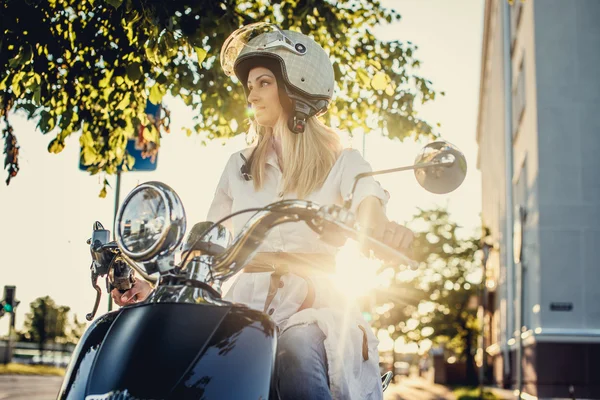 Blond girl on moto scooter