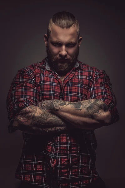 Man with beard and tattoo.