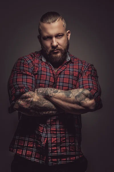 Man with beard and tattoo.