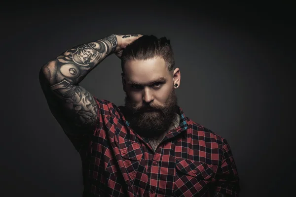 Man with beard and tattoes.