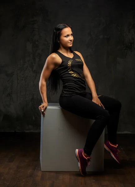 Fitness woman in black sportswear.