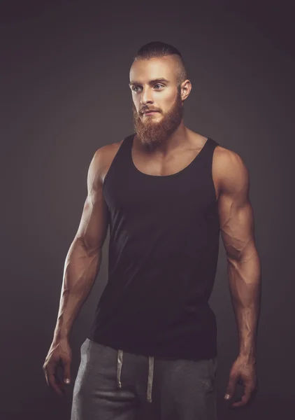 Athletic bearded man in black t shirt.