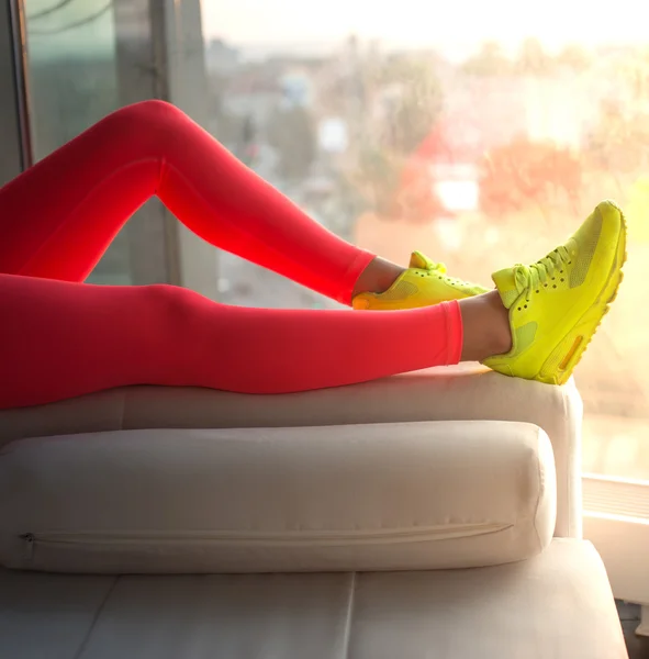 Woman\'s legs in red sports pants.