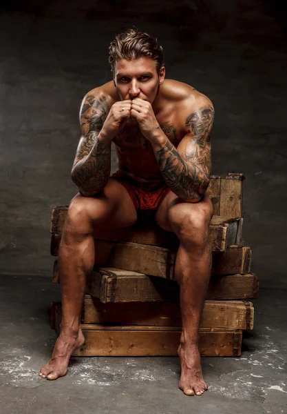 Naked muscular tattooed guy