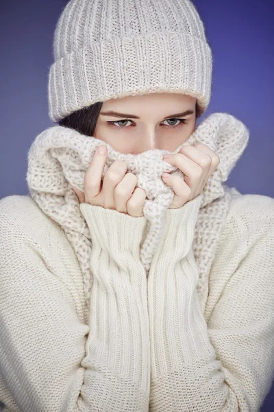 Young woman in white worm winter sweater.