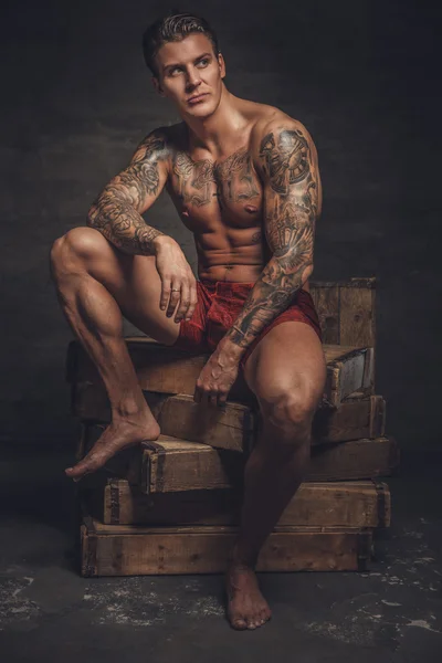 Naked muscular tattooed guy