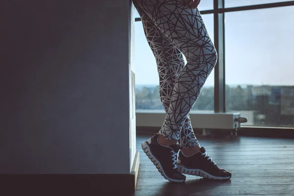 Woman\'s legs in a grey sport pants.