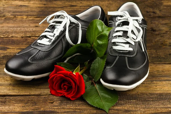 Black man\'s shoes and rose