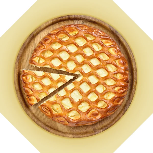 Wooden dish of cheese pie with one cut piece.